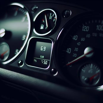 a car dashboard with a fuel and range gauge