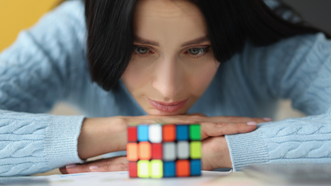 a women looking at a cube